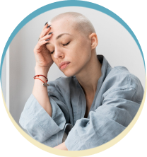 Woman with shaved head in thoughtful pose